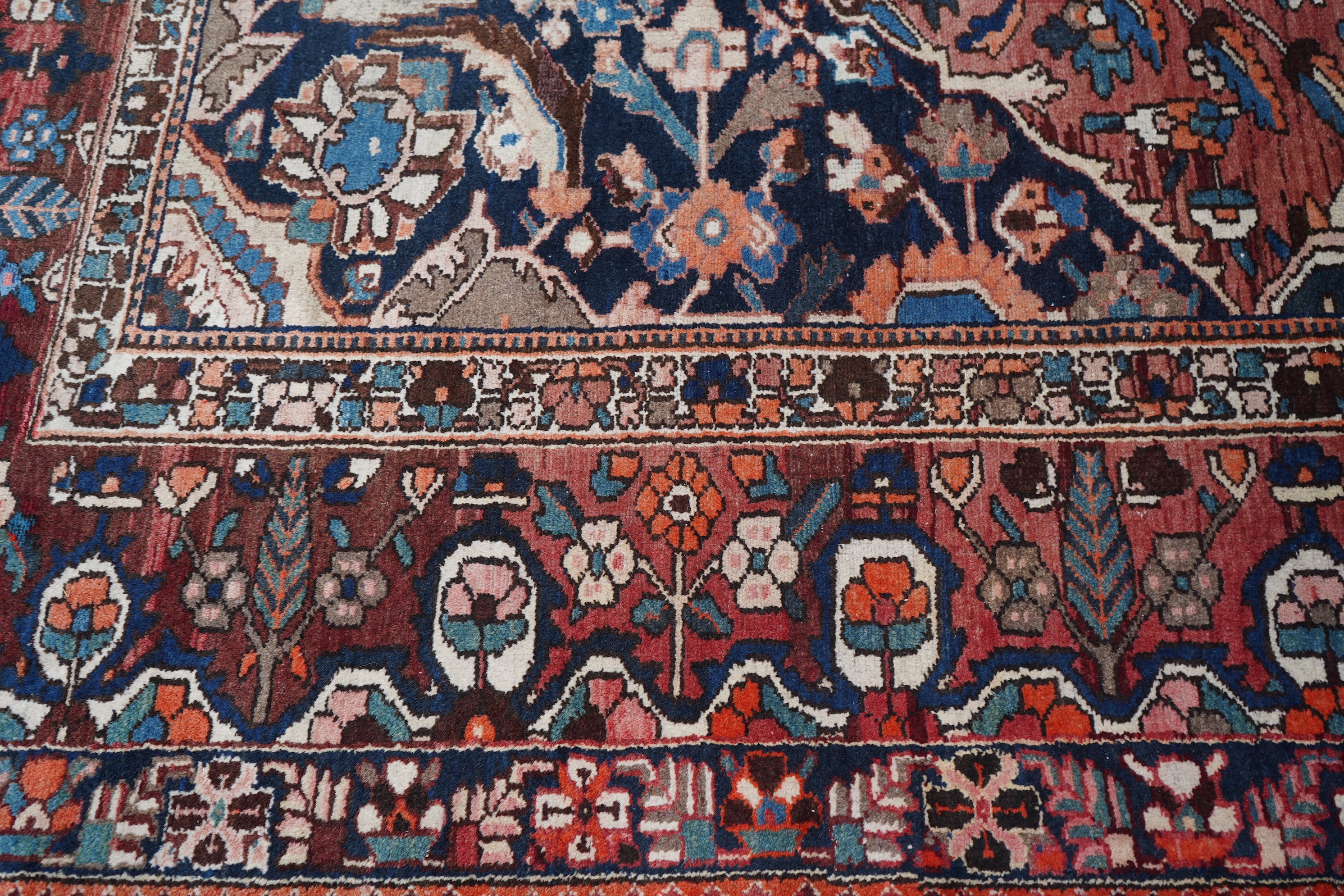 A Heriz brick red ground carpet